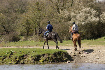 Horse riders on the Ogmore River in South Wales UK
