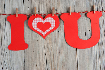 Phrase I LOVE YOU on old wooden background