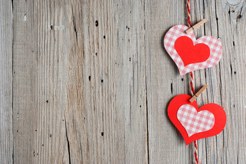 Paper hearts on old wooden background