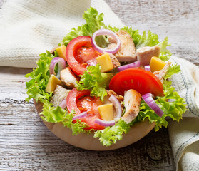 Salad with chicken, tomato, onion and cheese