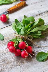 Fresh radishes on wooden background © Yulia Furman