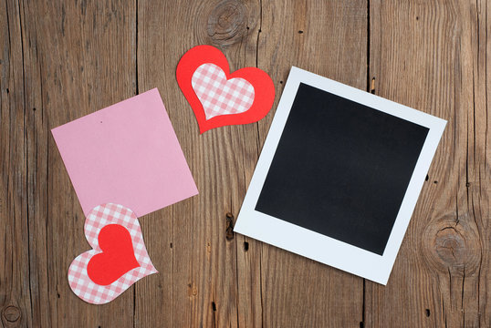 Instant photo with blank note and hearts
