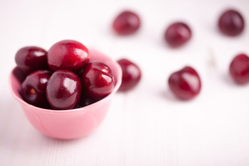 Cherries in a pink bowl