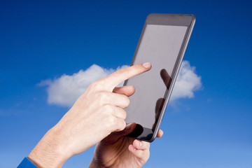 hands with tablet on natural background