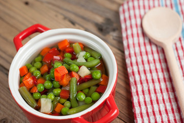 Vegetable soup on old wooden table