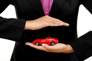 Business woman with a toy car in her hand