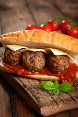 Sandwich with meatballs on rustic background