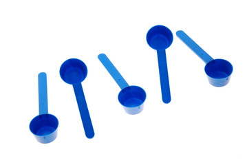 Blue plastic measuring spoons isolated on white background