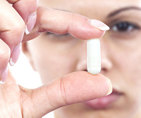 Young woman with capsule