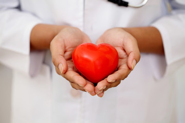 Female doctor holding a beautiful red heart shape - 81638756