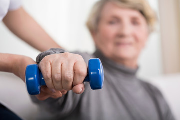 Elder woman training with physiotherapist