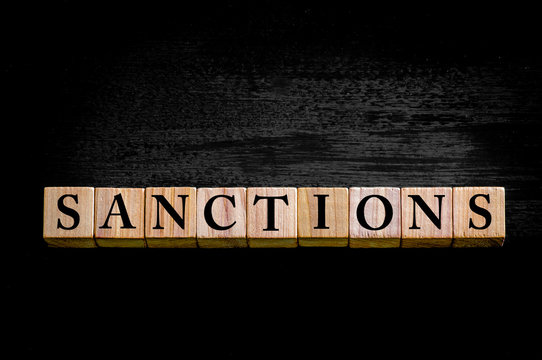 Word SANCTIONS isolated on black background