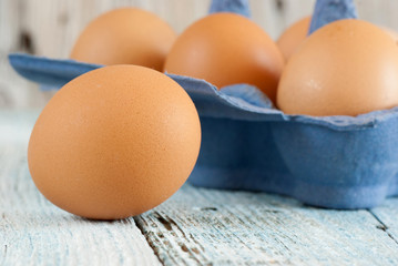 Eggs in box on old wooden table