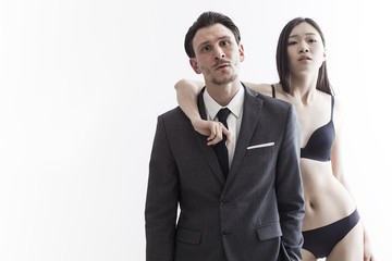 Handsome businessman and beautiful chinese model couple portrait