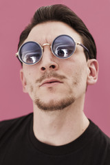Handsome man closeup portrait wearing blue sunglasses