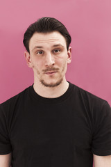 Fototapeta premium Handsome man portrait smiling on pink background