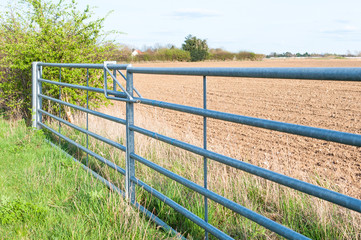 Fototapeta premium Side view of closed farmland metal gate in England