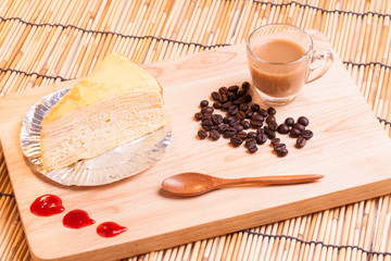 Fototapeta na wymiar vanilla crape cake and cup of coffee on wood.