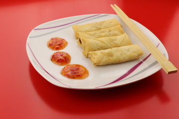 Spring rolls with sweet and sour dipping sauce on a plate