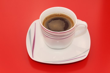 Isolated traditional Turkish coffee on a red background