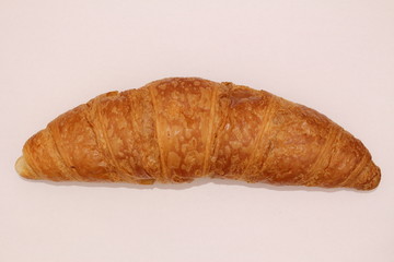 Isolated single butter croissant on a white background