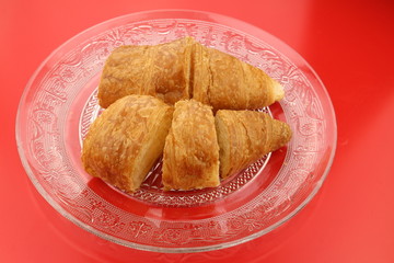 Sliced butter croissants on a glass plate