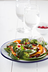 Salad with vegetables, pepperoni and pomergranate