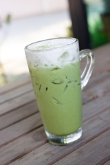 Glass of iced green tea latte.