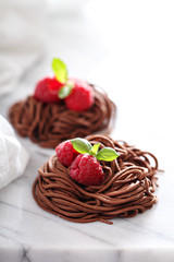 Raw chocolate pasta nests with raspberry