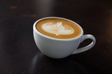 Cup of hot latte art coffee.