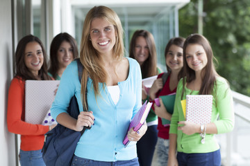 Smiling teenagers with exercise books