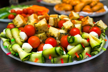 Canapes sandwiches of mozzarella cheese, tomato, cucumbers