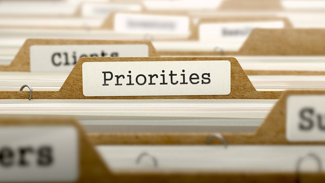 Priorities Concept with Word on Folder.