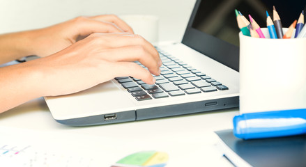 closeup hand typing on keyboard laptop business work
