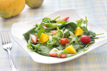 Fresh salad with fruits vegetables and greens