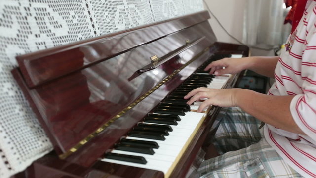Pianist playing piano in the house