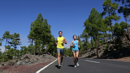 Young Fit Couple Running and Jogging on Road - Powered by Adobe