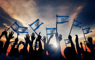 Silhouettes of People Holding Flag of Israel Concept