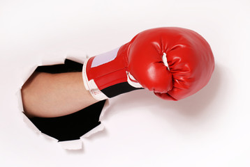 Hand in boxing glove through paper hole - 81652312