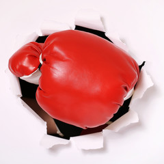 Hand in boxing glove through paper hole - 81652324