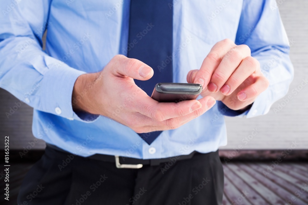 Aufkleber Composite image of close up of a businessman using a smartphone