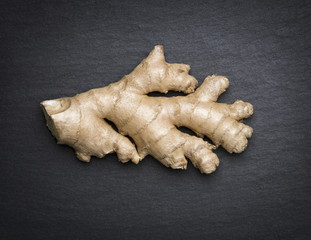 Ginger isolated on dark flagstone.