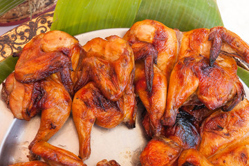 baked fried chicken carcass on metal Plate