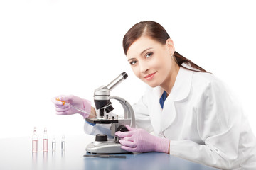 Woman using a microscope in a laboratory.