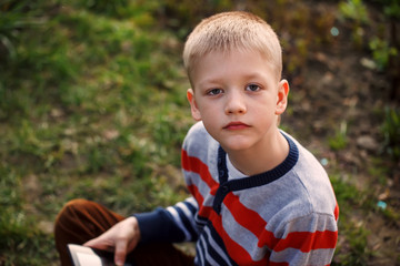 Happy boy outdoors using his tablet computer for educating