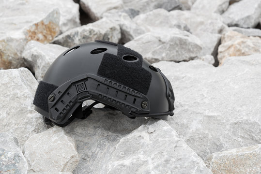 Special force Modern combat helmet on rock ground.