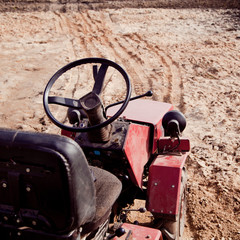 Little tractor a field in the spring 