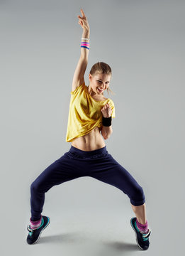 Happy girl working out zumba dance standing with hand up