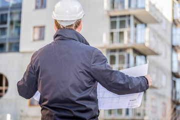 Construction manager with blueprints