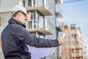 Construction manager with blueprints